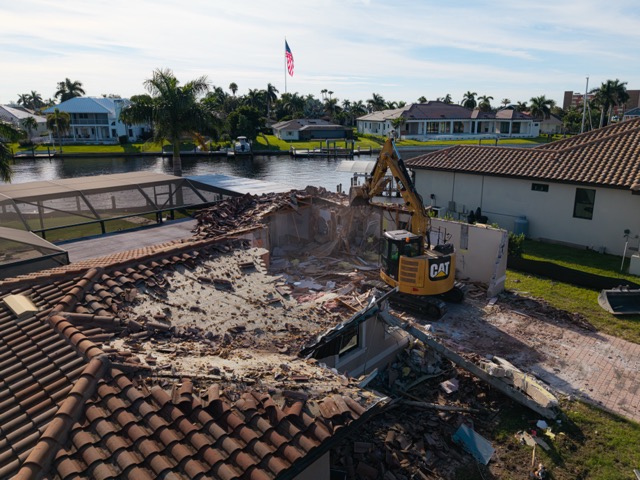 Wide aerial shot of a demolition site at golden hour